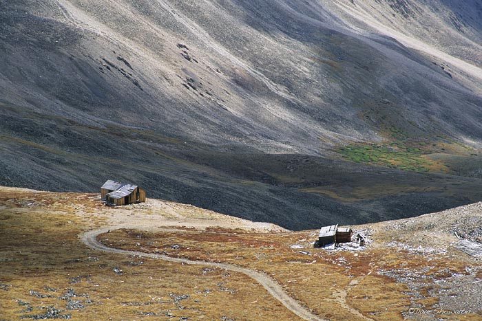 The Hilltop Mine is dwarfed by a massive mountain landscape, as seen from the 13,500' saddle of Mount Sherman - 14,042. Mount...